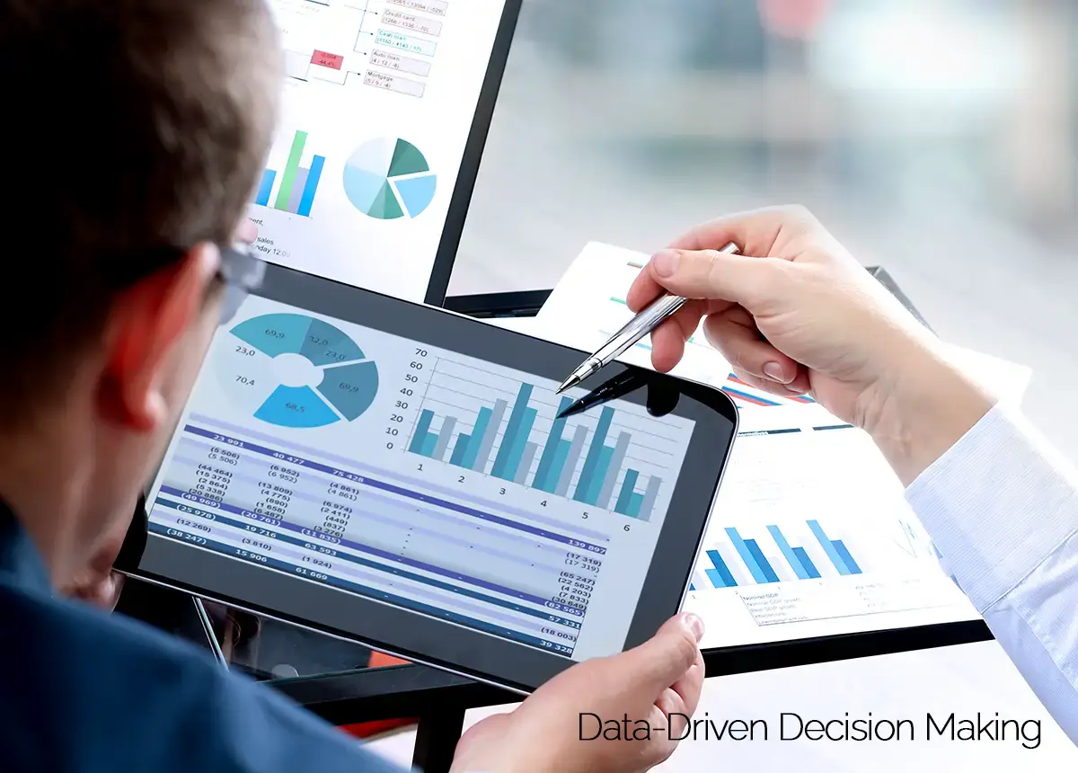 Data being analyzed on digital pad by 2 coworkers.