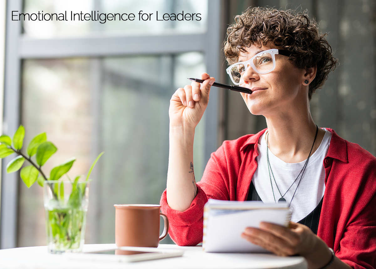 Female employee thinking while holding notepad and pen.