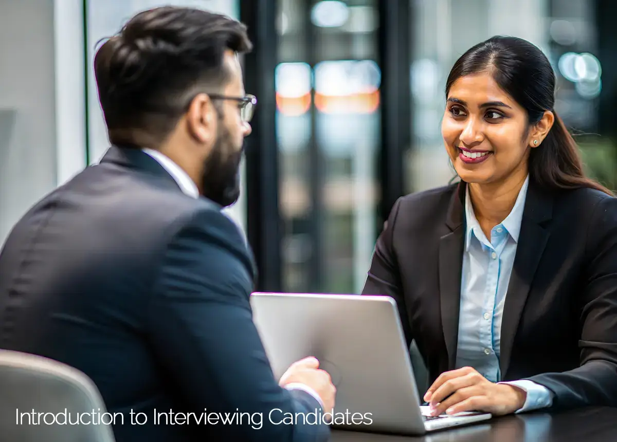 businesswoman interviewing a male candidate while taking notes on her laptop.