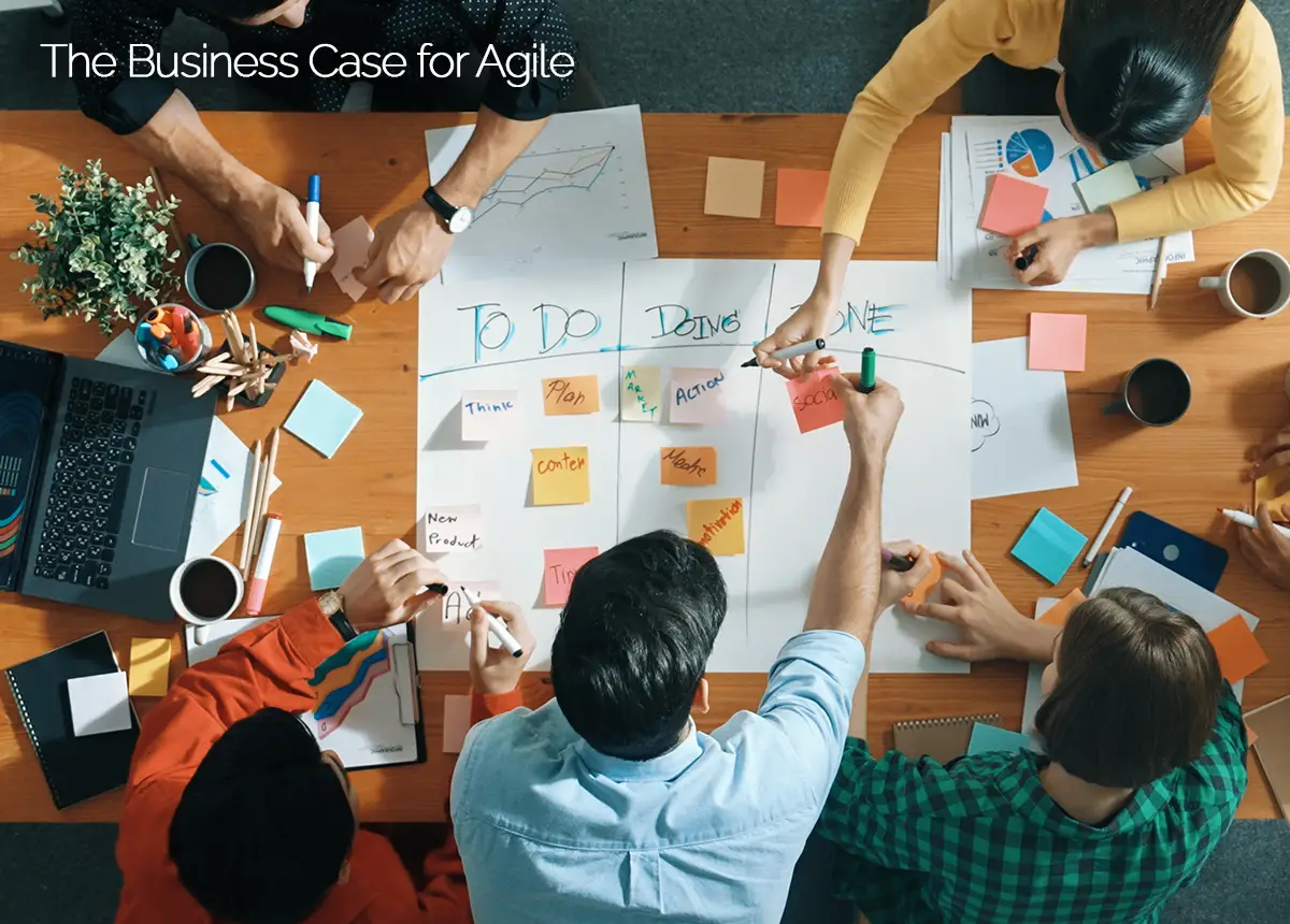 Business office workers over a big table with dozens of post it notes.