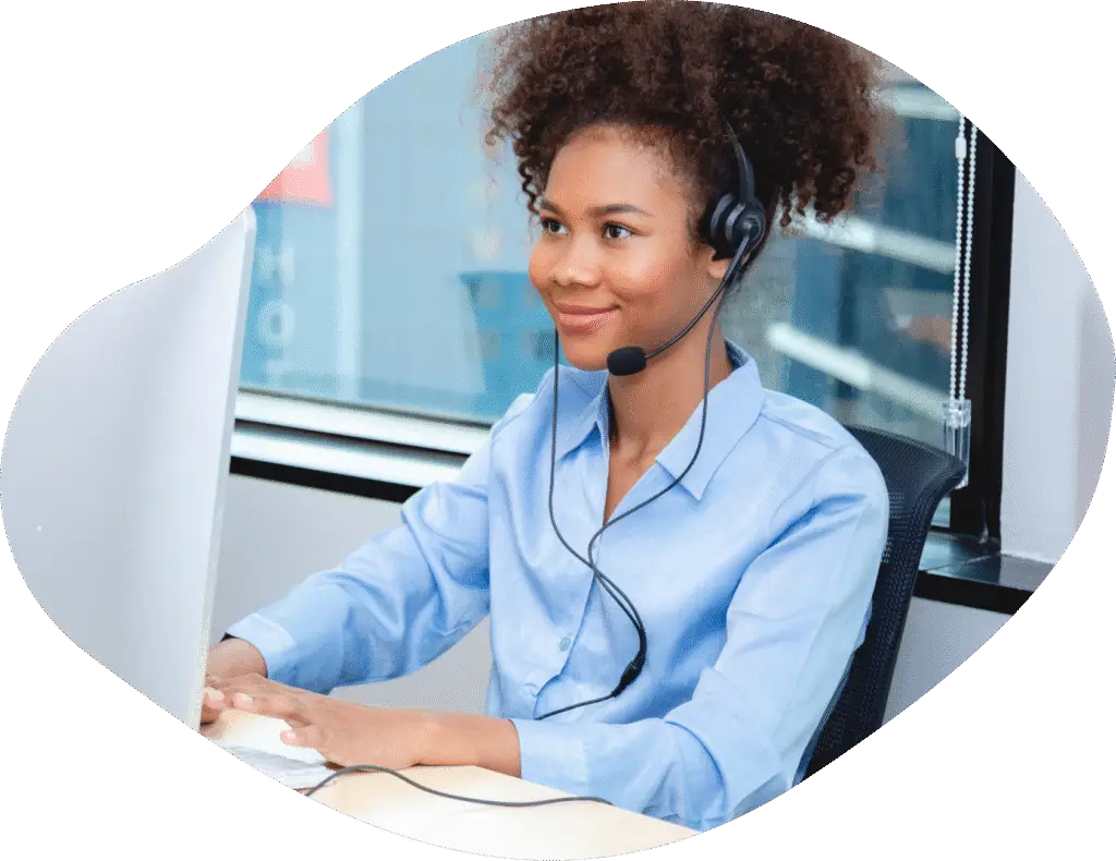Woman wearing a talking headset in a computer call while at work.