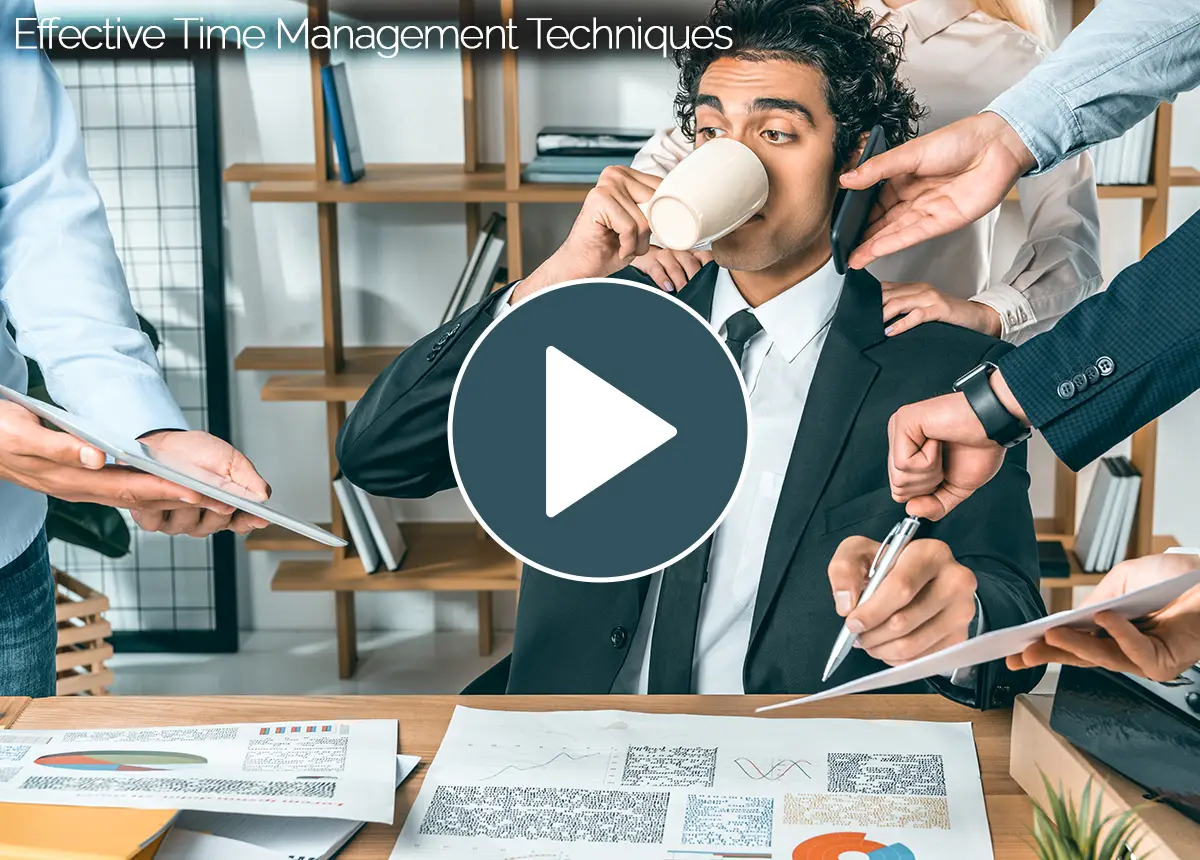 Intro video thumbnail for 'Effective Time Management Techniques' course, depicting an overwhelmed professional at a desk being handed multiple devices and documents.